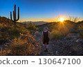 Hiker on King Canyon Trail in Saguaro National Park, Arizona, at Sunset 130647100