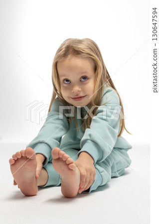 Portrait of beautiful cute little toddler girl. Child with funny face. Pretty smile kid in studio on white background. High quality photo 130647594