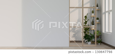 Empty white wall of a room with indoor potted plants at the end of wooden floor corridor or hallway. 130647798