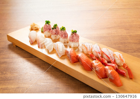 Assorted sushi with carefully selected ingredients: A Japanese masterpiece that showcases the craftsmanship of the chef Assorted sushi with carefully selected ingredients: A Japanese masterpiece that showcases the craftsmanship of the chef 130647916