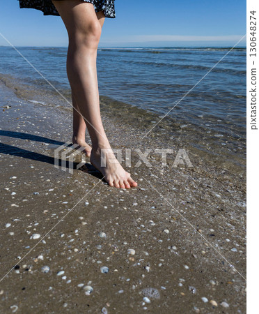 Woman leg walking on beach. Woman leg walking on beach. 130648274
