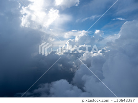 Dramatic sky with sunbeams and clouds seen from an airplane 130648387