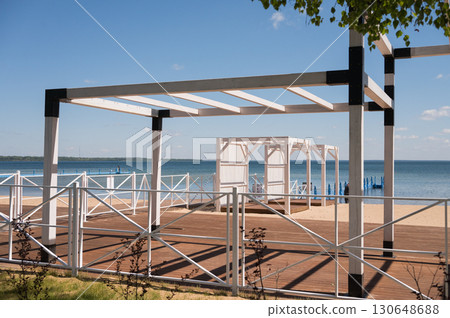 Seaside pergola with ocean view on sunny day Seaside pergola with ocean view on sunny day 130648688