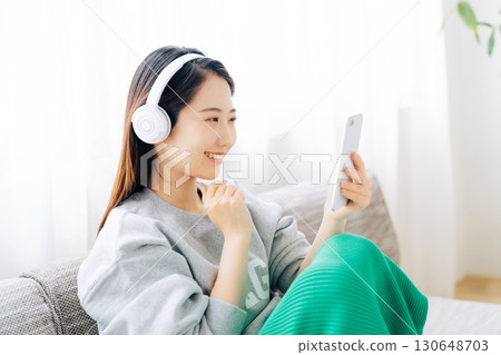 Woman listening to music on smartphone 130648703
