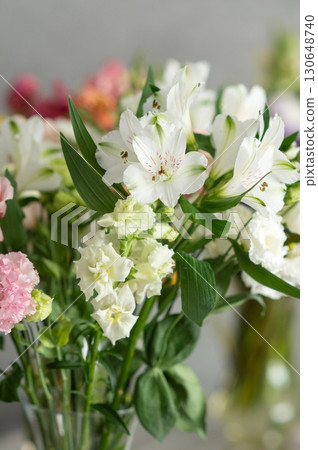 Vibrant bouquet of white flowers with green leaves in soft focus Vibrant bouquet of white flowers with green leaves in soft focus 130648740