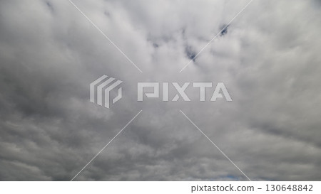 A Dramatic Overcast Sky with Soft, Billowy Clouds Casting an Ethereal Ambiance Overhead 130648842