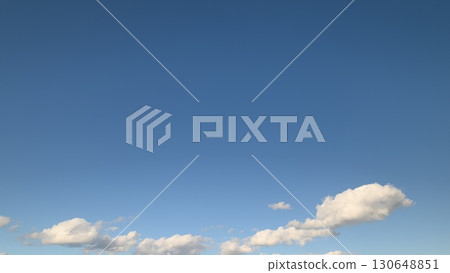 A beautiful serene blue sky filled with fluffy white clouds for everyone to appreciate today 130648851