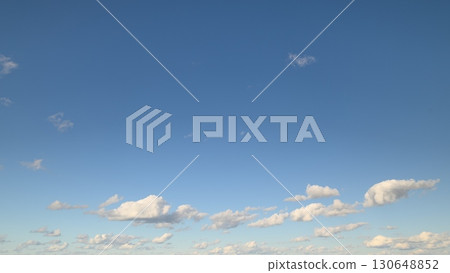 A Serene Blue Sky Adorned with Beautiful Fluffy Clouds on a Perfect and Blissful Day A Serene Blue Sky Adorned with Beautiful Fluffy Clouds on a Perfect and Blissful Day 130648852
