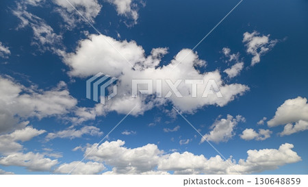 Enjoy the beautiful clear skies adorned with fluffy clouds, creating a serene atmosphere Enjoy the beautiful clear skies adorned with fluffy clouds, creating a serene atmosphere 130648859