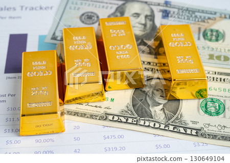Gold bar on US dollar and Euro banknote, economy finance exchange trade investment. Gold bar on US dollar and Euro banknote, economy finance exchange trade investment. 130649104