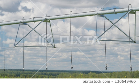 Innovative Modern Agricultural Irrigation System Beneath a Beautiful Blue Sky Atmosphere 130649460