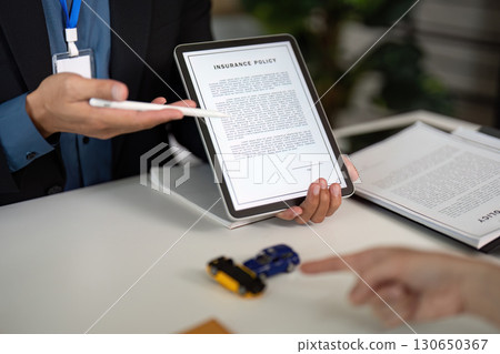 Digital Insurance Policy Presentation. Agent showing policy on tablet. 130650367
