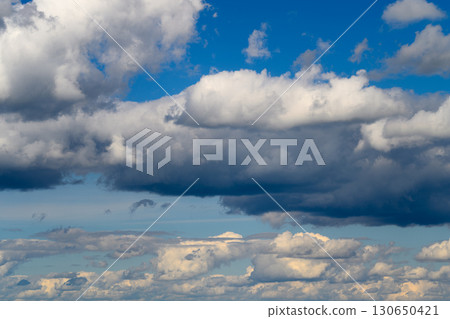 A Dramatic and Gorgeous Sky Featuring Fluffy Clouds with a Vibrant Blue Background A Dramatic and Gorgeous Sky Featuring Fluffy Clouds with a Vibrant Blue Background 130650421