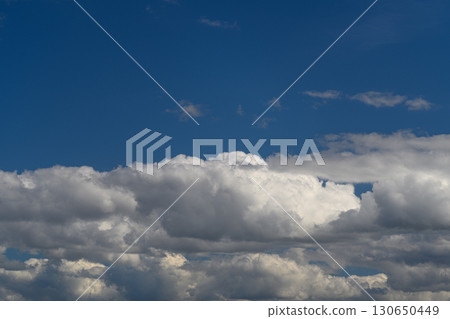 A Beautiful and Expansive Sky Decorated with Fluffy Clouds in a Clear Blue Atmosphere 130650449