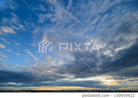 An Impressive and Dramatic Sky Display with Beautiful Clouds During a Stunning Sunset Exhibit 130650612