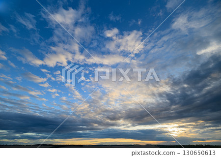 Experience a breathtaking sunset sky with vibrant clouds, capturing natures artistry 130650613