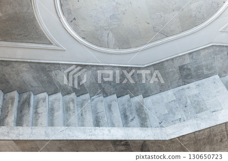 Blue toned tilt view of a marble staircase showcasing minimalist architecture 130650723