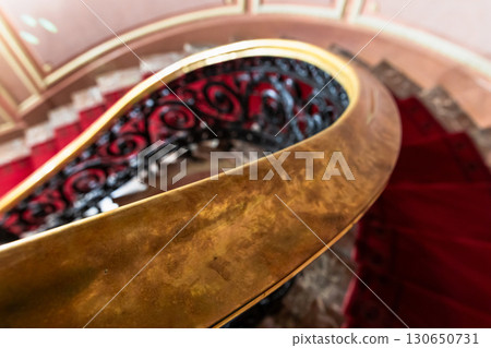 Close-up of a polished gold colored stair rail, classic architecture details 130650731