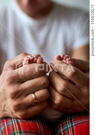Newborn Baby Feet in Parent's Hands Newborn Baby Feet in Parent's Hands 130650873
