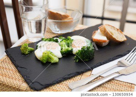 breakfast of crumpled eggs with broccoli 130650934
