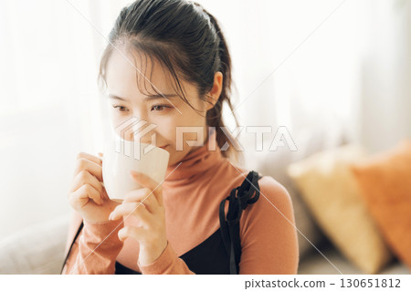 A woman drinking hot drinks A woman drinking hot drinks 130651812
