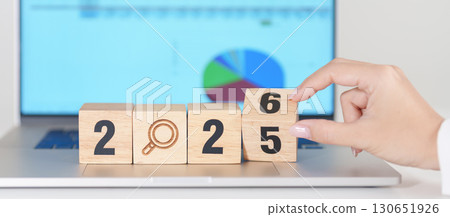2025 end year to Happy New Year 2026 block with magnifying glass icon against laptop computer. SEO, Search Engine Optimization, hiring , Advertising, Strategy, marketing, Keyword, Content and New year 130651926