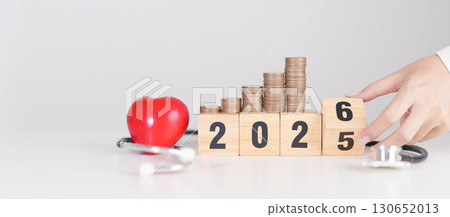 Happy New Year 2026 with doctor Stethoscope, coins stack and red heart on table. health care, Money saving, Goal, Resolution, health Insurance, Wellness and medical concept Happy New Year 2026 with doctor Stethoscope, coins stack and red heart on table. health care, Money saving, Goal, Resolution, health Insurance, Wellness and medical concept 130652013