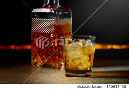 Whiskey with ice on a dark background. Whiskey with ice on a dark background. 130652486