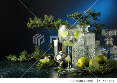 Cocktail gin and tonic with ice and lime slices. Cocktail gin and tonic with ice and lime slices. 130652524