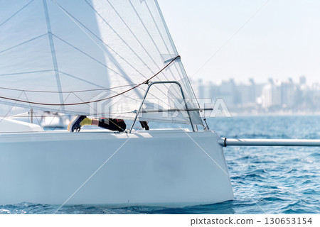 Sailor is hanging off a sailing yacht during a regatta 130653154