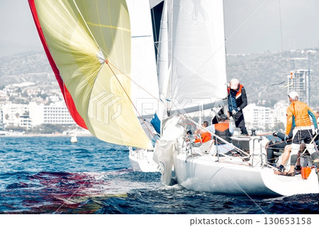 Sailboat crew navigating during regatta competition Sailboat crew navigating during regatta competition 130653158