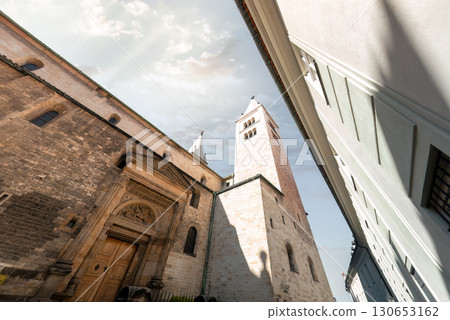 The imposing facade of St. George's Basilica captured from a low angle, showcasing its Romanesque architecture. Prague Castle 130653162