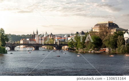 Prague cityscape with people boating on the sunny Vltava river. Czech Republic Prague cityscape with people boating on the sunny Vltava river. Czech Republic 130653164