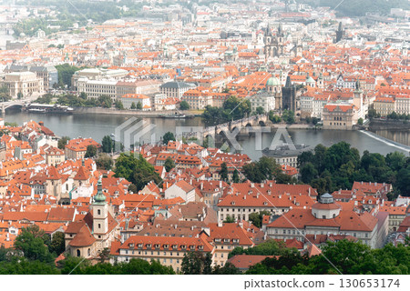 Aerial view of Prague's cityscape, showcasing its traditional architecture and the iconic Charles Bridge spanning the Vltava river 130653174