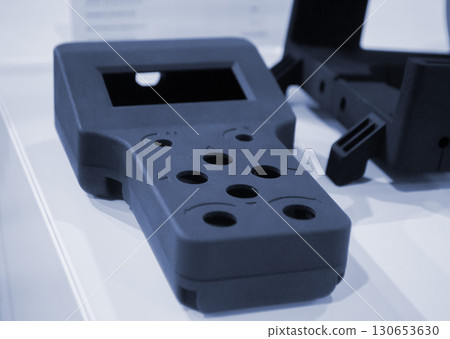 Object printed on 3D printer from molten plastic powder close-up. Model of black color printed on 3D printer from melted polyamide powder. Modern additive 3D printing technology. Multi Jet Fusion MJF 130653630