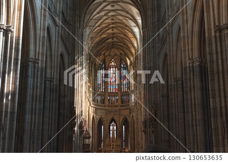 Sunlight streaming through stained glass windows in gothic St. Vitus Cathedral. Prague, Czech Republic 130653635