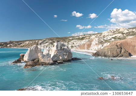 Turquoise waters gently lap the rocky shore of aphrodite's rock beach in cyprus 130653647