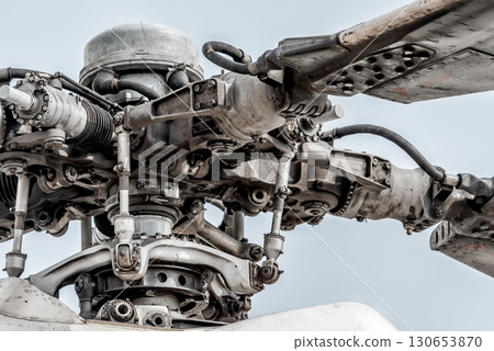 Rotor head of a helicopter with blades showing mechanical detail Rotor head of a helicopter with blades showing mechanical detail 130653870