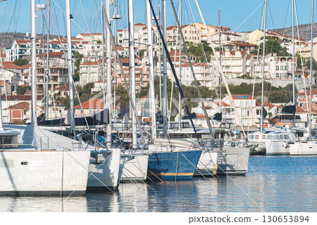 Yachts docked in marina with coastal town in background, Rogoznica, Croatia Yachts docked in marina with coastal town in background, Rogoznica, Croatia 130653894