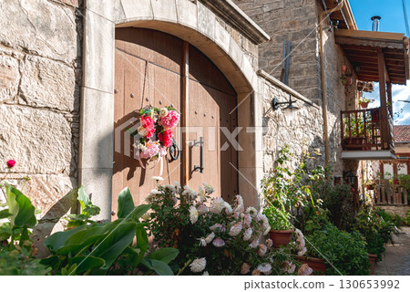 Old wooden door with flower wreath in Vouni village, Cyprus Old wooden door with flower wreath in Vouni village, Cyprus 130653992