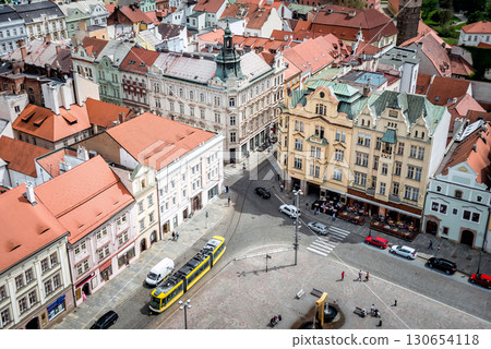 Yellow tram passing through picturesque city square in Plzen city. Czech Republic 130654118