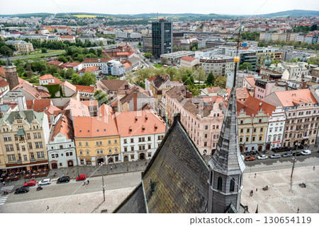 St. Bartholomew cathedral steeple overlooking picturesque Old Town of Plzen square with colorful buildings. Czech Republic 130654119