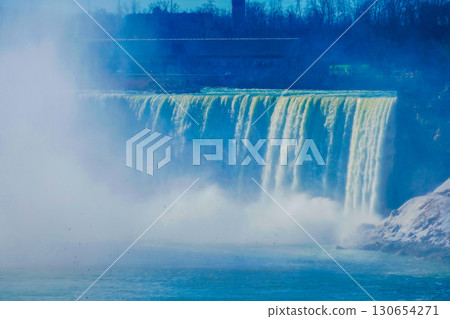 Winter waterfall and Niagara Falls in the blue sky Winter waterfall and Niagara Falls in the blue sky 130654271