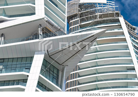 Modern white skyscraper under construction with glass balconies. Limassol, Cyprus 130654790