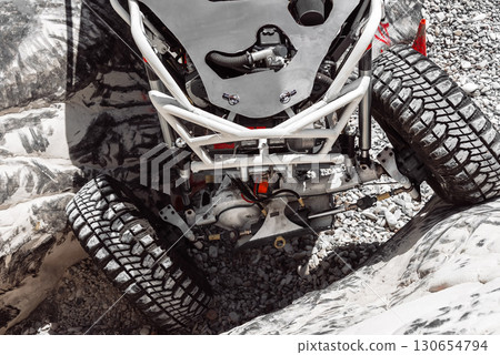Powerful off road buggy climbing rock during competition 130654794
