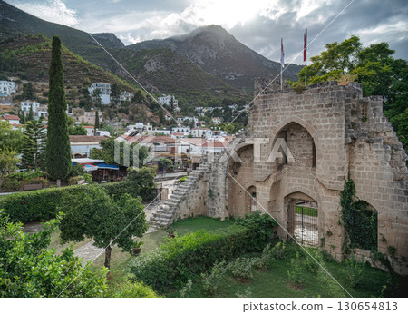 Medieval Bellapais Abbey ruins towering over picturesque Bellapais village in the Kyrenia Mountains, Cyprus 130654813