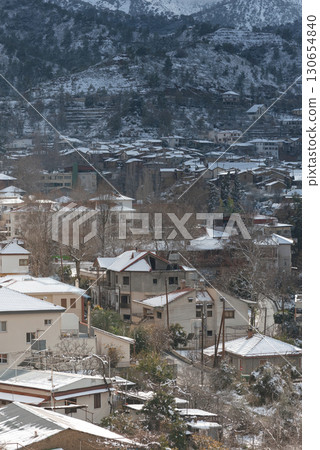 View of Kakopetria village with its houses and the Troodos mountains covered in snow during wintertime in Cyprus 130654840