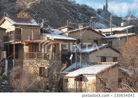 Traditional stone houses covered in snow in Kakopetria village 130654841
