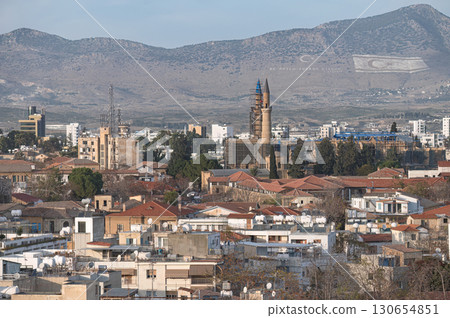 Selimiye Mosque dominating skyline of Nicosia, Cyprus with Turkish and TRNC flags on Kyrenia mountain range 130654851
