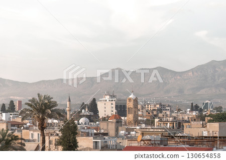 Cityscape of Nicosia, Cyprus, showing mosques and churches with Pentadactylos (Kyrenia) mountains in the background Cityscape of Nicosia, Cyprus, showing mosques and churches with Pentadactylos (Kyrenia) mountains in the background 130654858